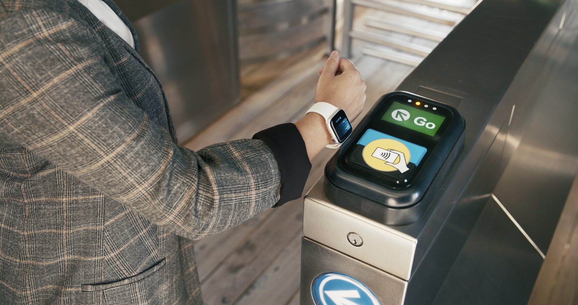 Customer using Ventra Card on their Apple Watch to pay at a CTA rail turnstile.
